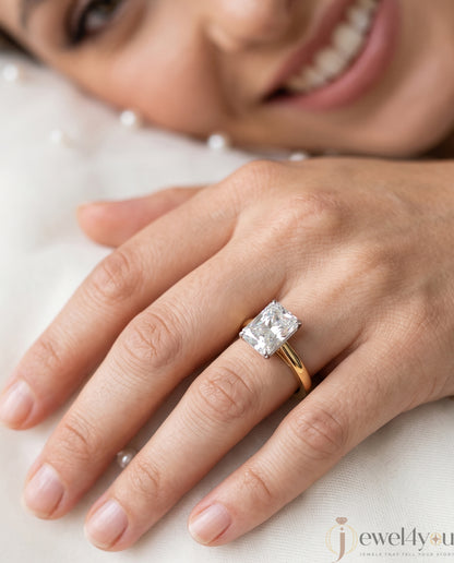 Radiant-cut solitaire ring in yellow gold showing cathedral shoulders and prong setting #YELLOW GOLD