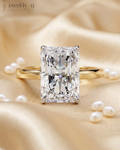 Radiant-cut solitaire ring in yellow gold showing cathedral shoulders and prong setting #YELLOW GOLD