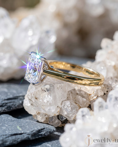 Radiant-cut solitaire ring in yellow gold showing cathedral shoulders and prong setting #YELLOW GOLD