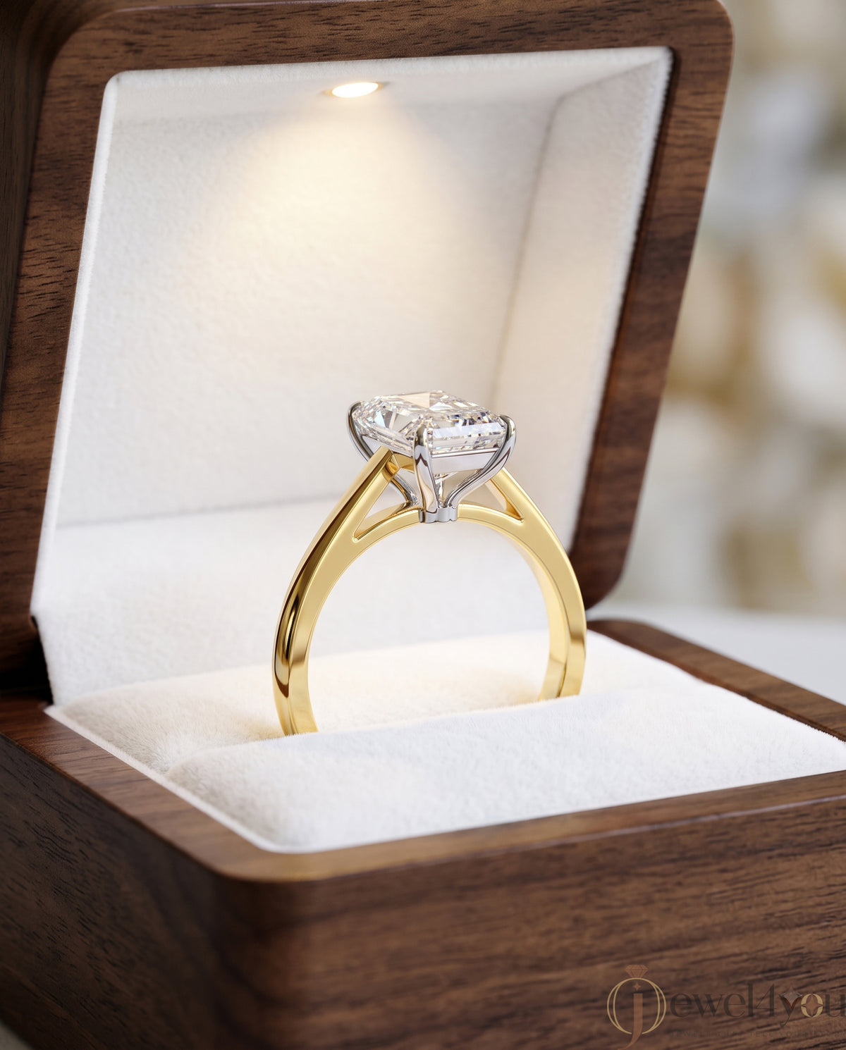 Radiant-cut solitaire ring in yellow gold showing cathedral shoulders and prong setting #YELLOW GOLD